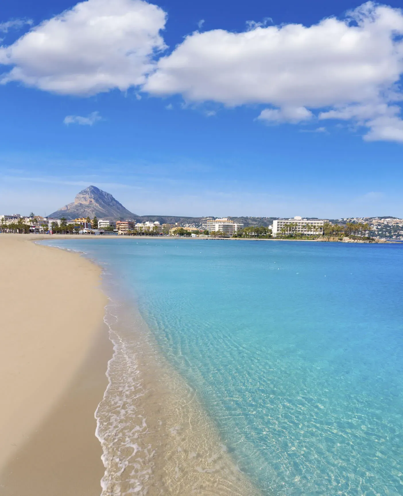 Arenal beach in Jávea, with clear turquoise water and Montgó mountain behind